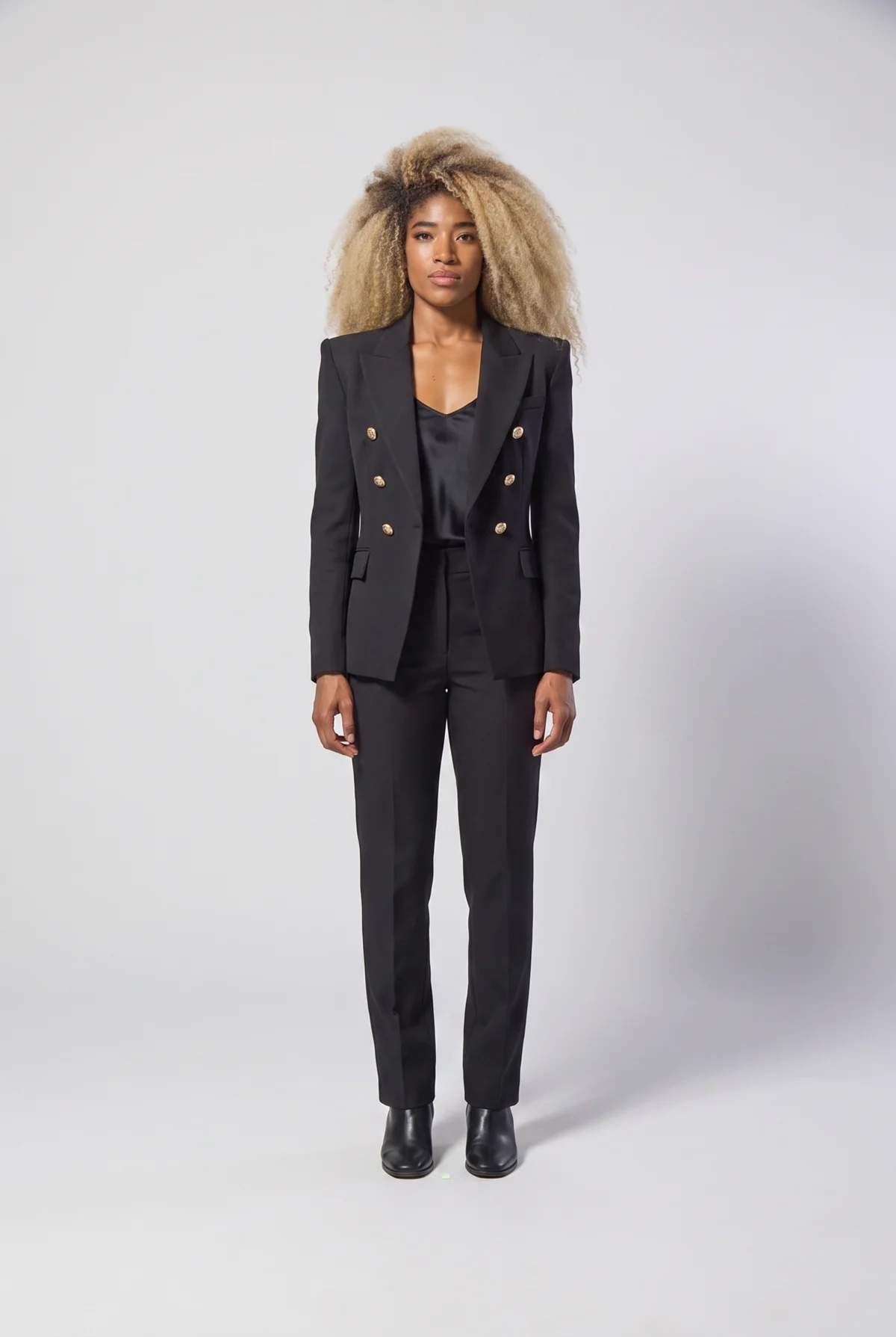 Black double-breasted blazer with peak lapel, structured shoulder